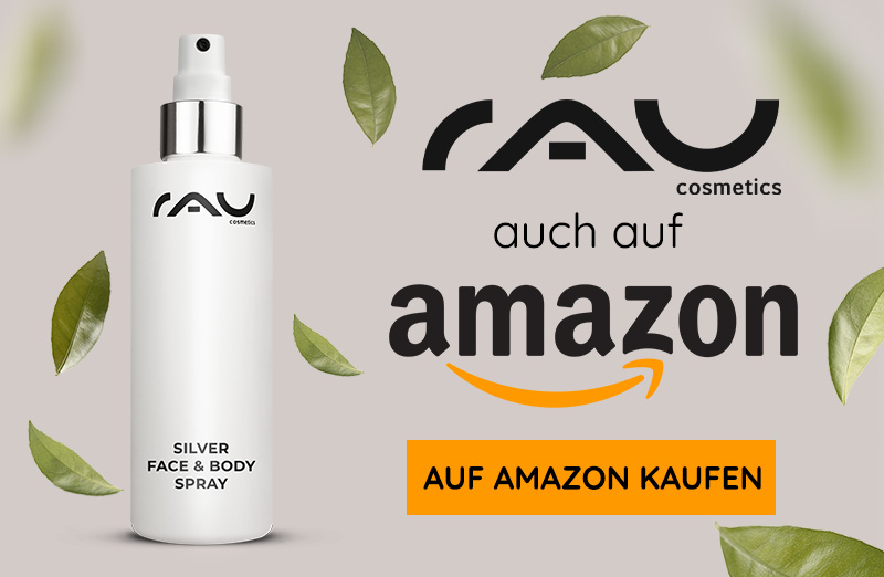 RAU Cosmetics Silber Gesichts- & Körperspray in moderner Flasche mit Spraykopf und grünen Blättern im Hintergrund.
